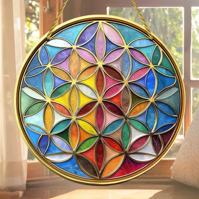 Sonnenfänger "Blume des Lebens" aus Acryl am Fenster, fängt Sonne ein und verwandelt sie in bezaubernde Farbspiele.