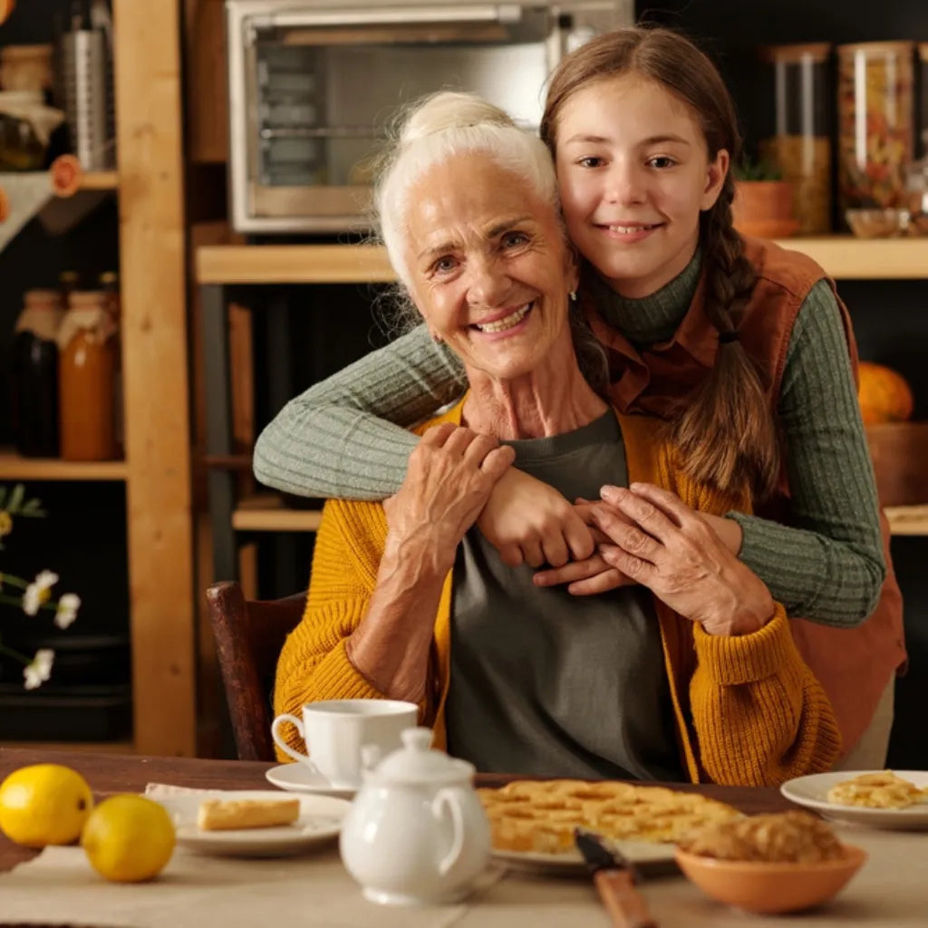 Großmutter und Enkelin umarmen sich, symbolisiert Liebe, Verbundenheit und den Kreislauf des Lebens.