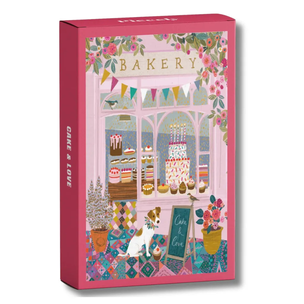 Piecely Minipuzzle 99 Teile "Cake & Love" Produktverpackung. Zeigt eine charmante Bäckerei-Fassade mit einem Hund, bunten Torten und festlicher Blumendekoration.