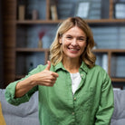 Frau zeigt Daumen hoch, symbolisiert innere Ruhe & Zufriedenheit durch christliche Meditation.