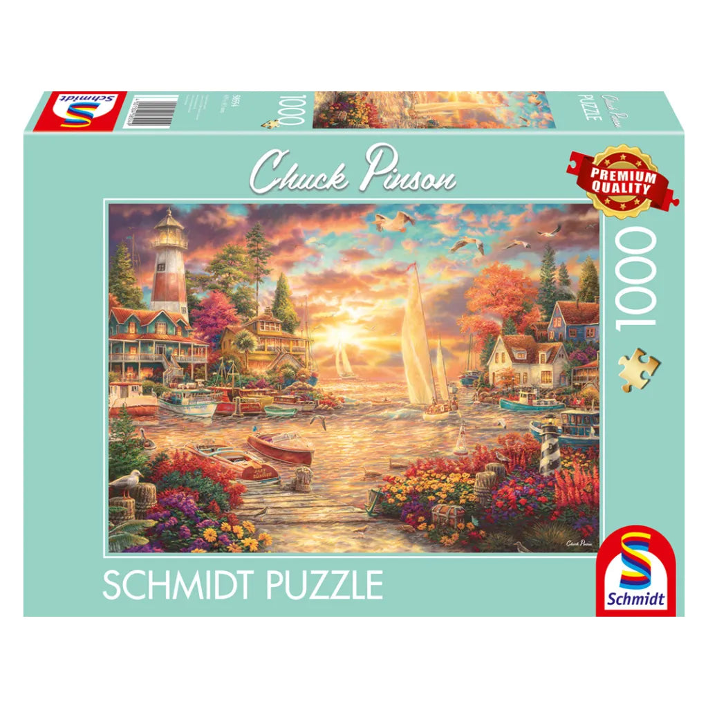 Schmidt Puzzle 1000 Teile "Morgenstille am See" von Chuck Pinson. Die Produktverpackung zeigt das Motiv mit Hafen, Leuchtturm und Booten im Morgenlicht.